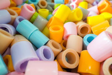 Short plastic tube pieces stacked on top of each other. Plastic waste and recycling concept