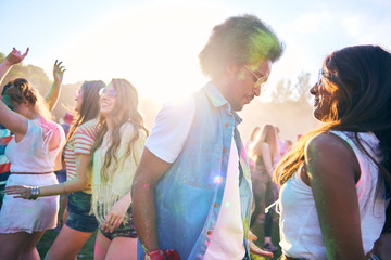 Enthusiastic crowd dancing at music festival