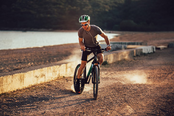 Man ride mountain bike on the beach. Sport and active life concept.