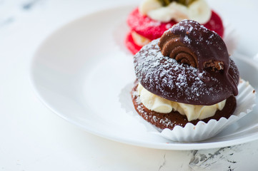 Two types of whoopie pies on plate.