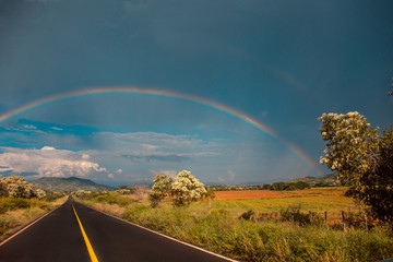 rainbow over road