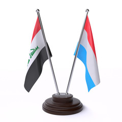 Iraq and Luxembourg, two table flags isolated on white background. 3d image
