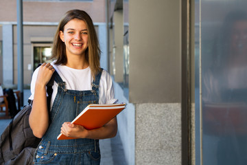 Smiling student girl at the school entrance