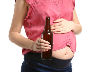 Pregnant woman with bottle of beer on white background