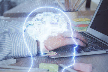 Man typing on keyboard background with brain hologram. Concept of big Data. Double exposure.