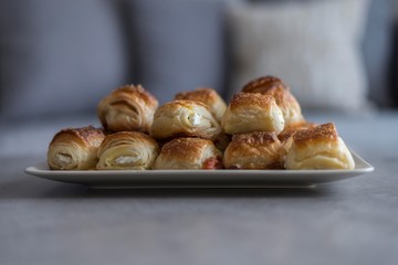 Croissant in plate on wooden table.