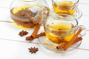 teapot and cups of tea on a white wooden background
