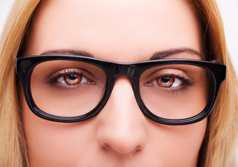Beautiful young woman wearing glasses. Close-up shot.