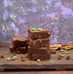 stack of baked square pieces of chocolate brownie pie