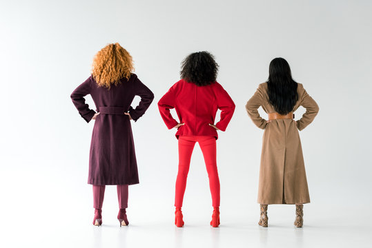 Back View Of Brunette And Redhead Women Standing With Hands On Hips On White