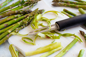 Fresh asparagus with a peeler