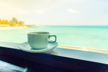 Coffee cup with Beautiful tropical Maldives island .  ( Filtered image processed vintage effect. )