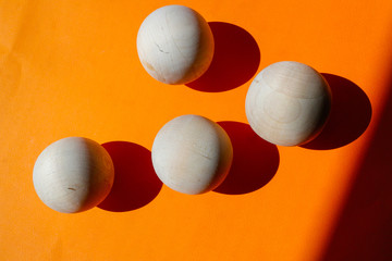 The wooden balls on the orange paper.