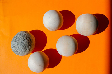 The wooden balls on the orange paper.