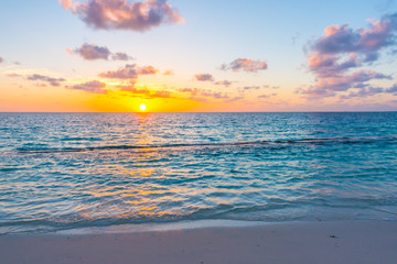 Beautiful sunset with sky over calm sea  in tropical Maldives island
