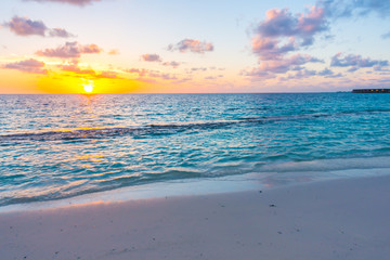 Beautiful sunset with sky over calm sea  in tropical Maldives island