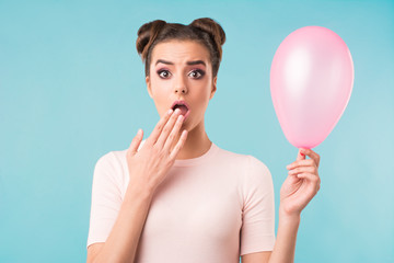 surprised brunette with a pink balloon 