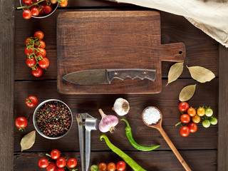 old brown empty kitchen cutting and fresh red cherry tomatoes with green chili peppers