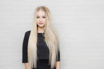 Concept hair care. Straight and tangled curls blonde girl. Straightening ,smoothing head. Before and after treatment.