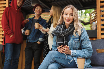 Cheerful young girl using mobile phone