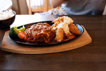 Steak with fried shrimp and Japanese style on a wooden table.