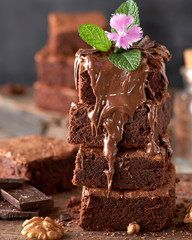 stack of square pieces of baked brownie chocolate poured on brown wooden board