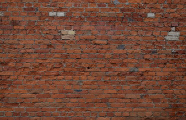 The unique fine texture of the old, partially destroyed brick terracotta wall of the house