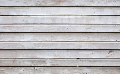 Unique texture painted with gray oil paint wooden planks of the old building with ranks of hammered nails