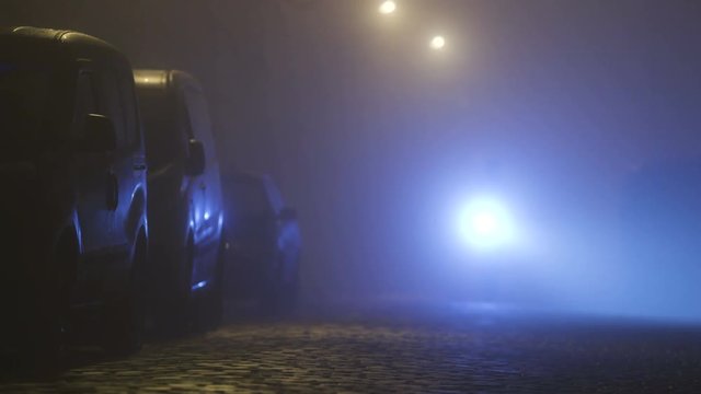 The man with a flashlight walking on the street. evening night time