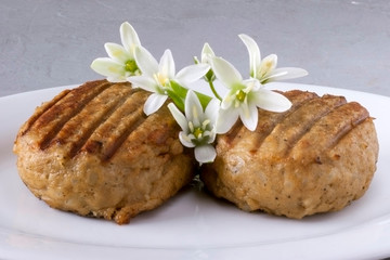 Two tasty juicy cutlets on a white plate