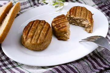 Two tasty juicy cutlets on a white plate