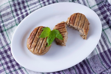 Two tasty juicy cutlets on a white plate