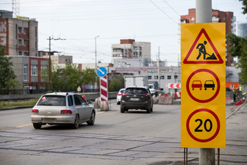 Damaged asphalt road. Repair of engineering road highways. Bad road. Detour sign on the road especially dangerous pits. Dangerous road. Emergency road. Wounds on the road