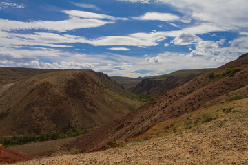 Red mountains in Kyzyl-Chin valley in Altay. Beautiful landscape. Summer time.