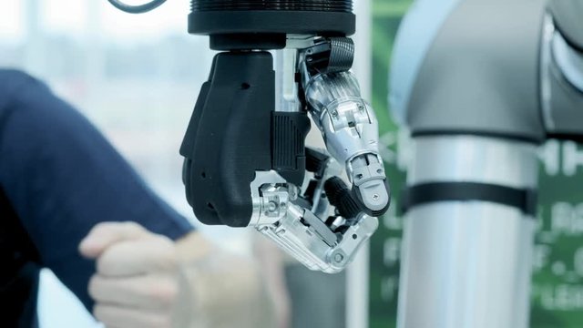 Modern technology today. Robotic human arm is a manipulator. Modern prosthetic limbs. Future is now. The thumb is moving to the right. Futuristic bionic arm