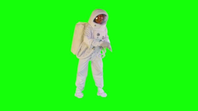  astronaut dancing on a green background