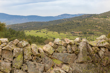 Mountain landscape with a stone wall in the foreground