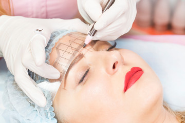 Obraz na płótnie Canvas Mikrobleyding eyebrows workflow in a beauty salon 