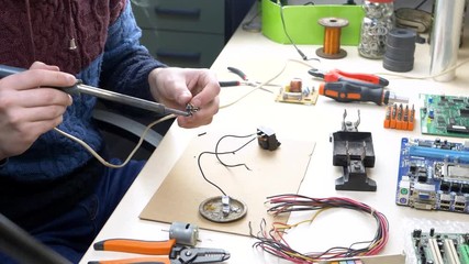 Young Man Repairing Motherboard from PC. Repair Shop and Electronic Devices Concept