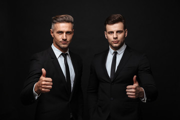 Two confident handsome businessmen wearing suit