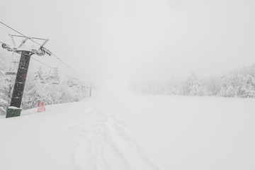 Ski lift over snow mountain in ski resort .