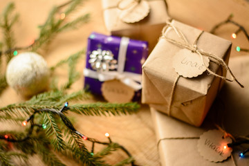 Chirstmas gift boxes on wooden table near the christmas tree