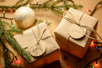 Christmas holiday composition of gift boxes on wooden background near the  branch of the fir tree