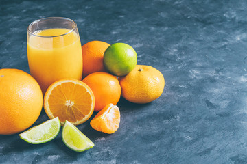 Citrus and juice decorated with mint on a blue background