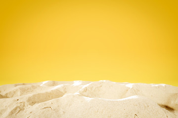 Summer background of sand and yellow wall space 