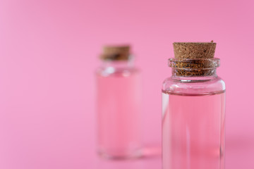 Rose liquid bottle on pink background