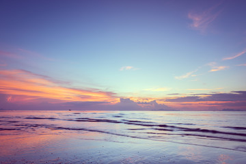 Fototapeta na wymiar Beautiful tropical pink blue sea sunset and yellow clouds baclground