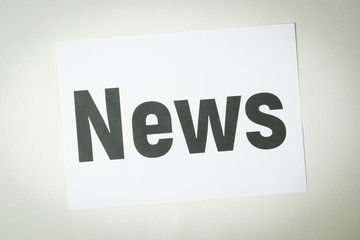 NEWS inscription on white paper