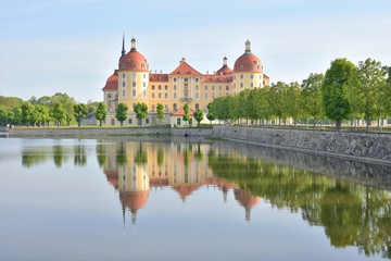 Exquisite medieval castle Moritzburg built in the Baroque style in the 16th century, Germany, Saxony. Traveling concept background. The magnificent castle Moritzburg surrounded by a lake and a beautif