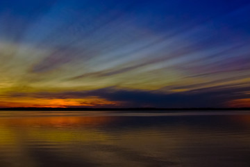 elongated feather clouds at sunset